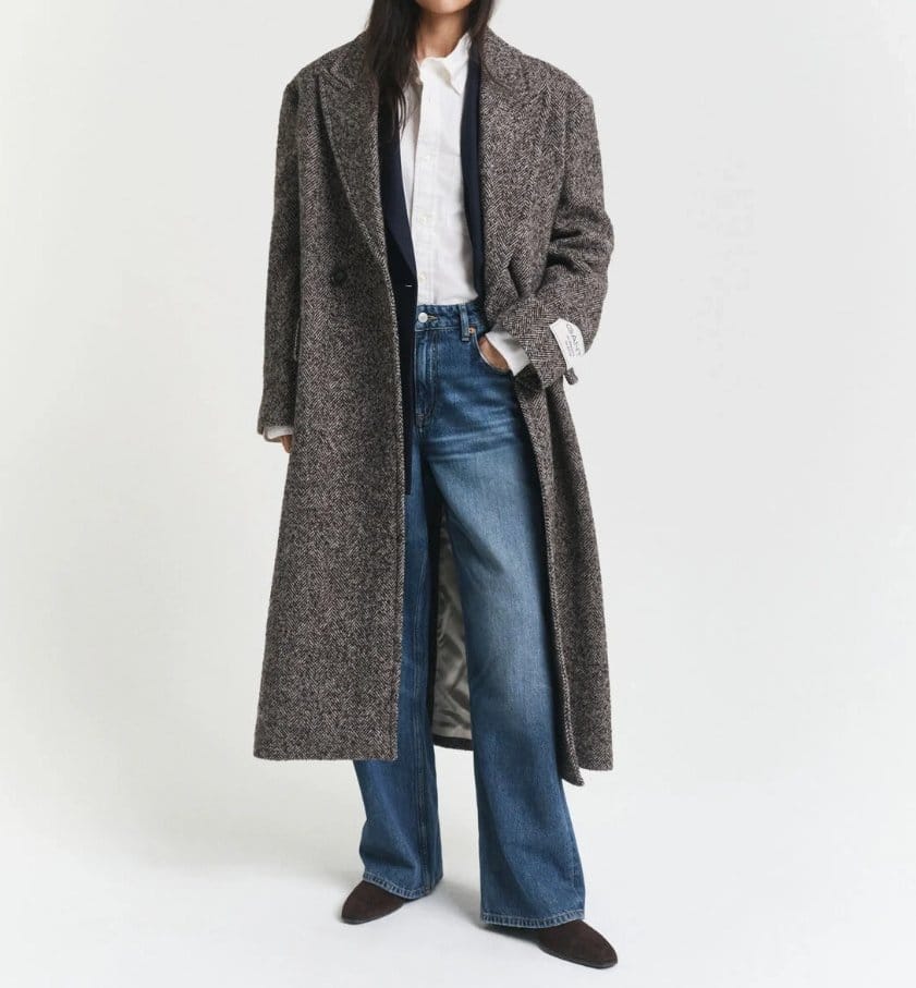 Long herringbone wool overcoat styled casually with jeans and shirt
