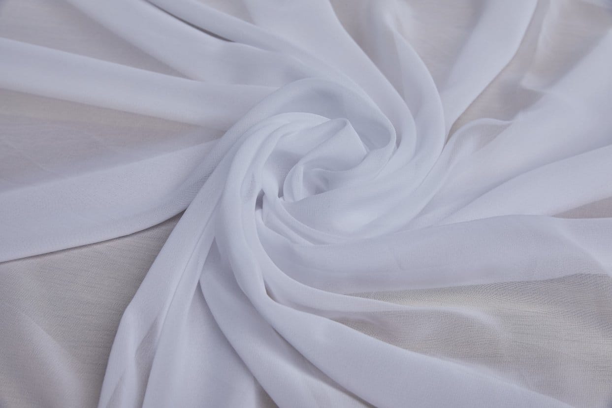 Polyester chiffon fabric with flowing layers and translucent finish