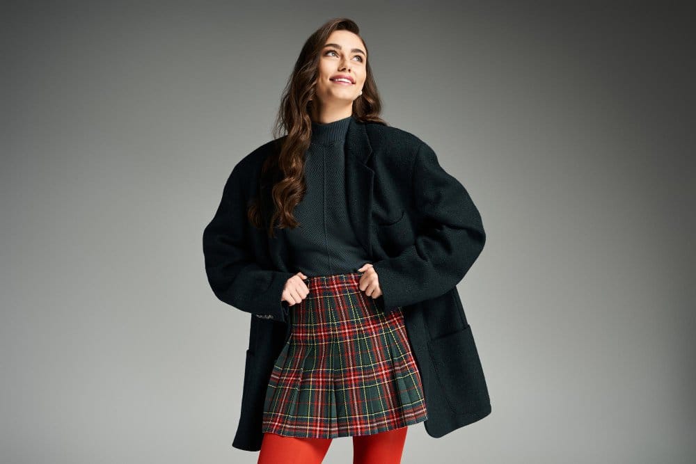 Woman wearing tartan wool skirt styled with modern fashion outfit