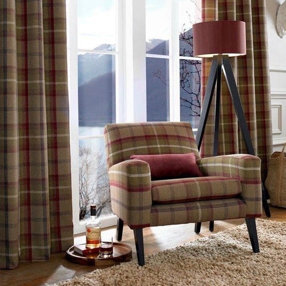 Tartan wool curtains framing window with matching tartan armchair in living room