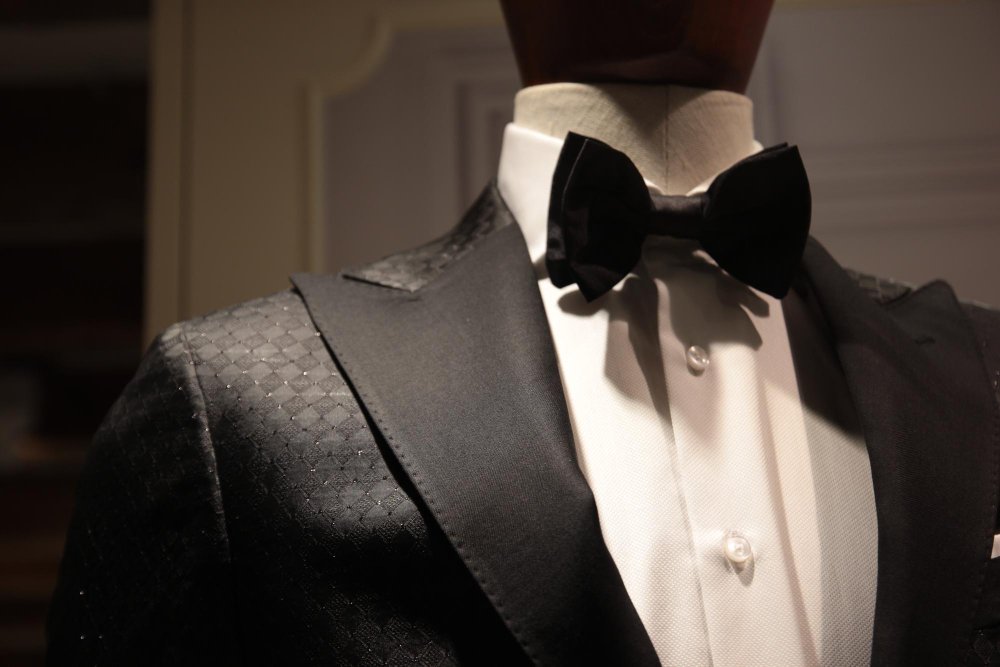 Tailored jacket being examined to assess wool barathea quality and finish