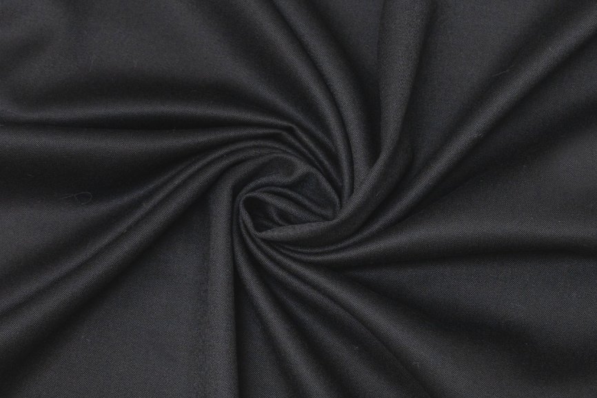 Close up of wool barathea fabric showing pebbled weave and structured drape