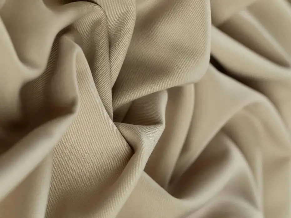 Soft folded wool gabardine fabric showing smooth surface and twill weave detail