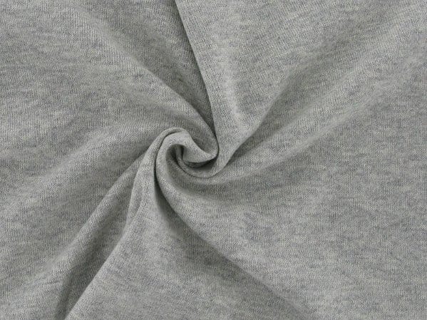 Close up of wool jersey fabric showing soft texture stretch and smooth surface