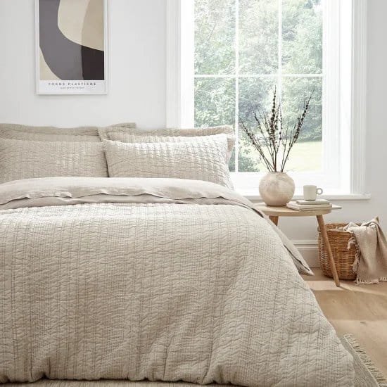 Bedding made with wool jersey fabric in a bright minimal bedroom