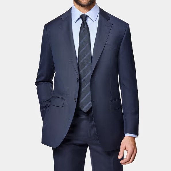 Full view of a tailored wool sharkskin suit styled for formal business or evening wear. Credit: Hawes & Curtis