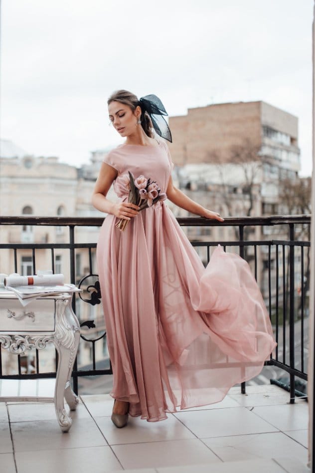 Dusty Rose flowing maxi dress with floral waist detail styled on city balcony