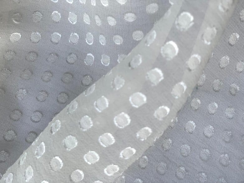 Fil coupé fabric with raised dot texture on sheer chiffon base, luxury textile with burnout style detailing