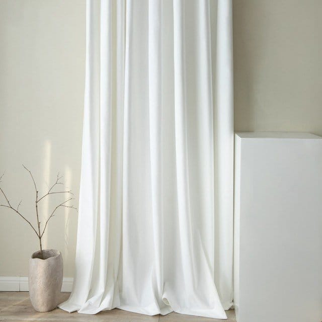 White georgette chiffon curtains hanging in a modern minimalist interior