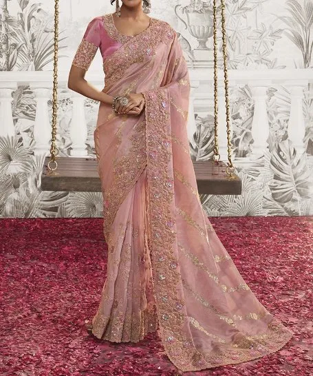 Peach georgette chiffon saree with heavy gold embroidery worn for a celebration