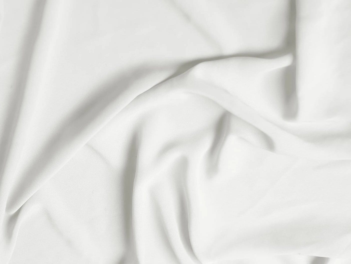 Soft white stretch chiffon fabric arranged in flowing folds