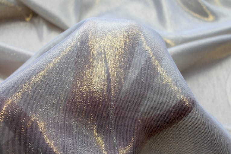 Close up of lurex chiffon fabric showing metallic shimmer and smooth drape