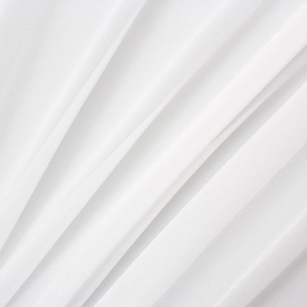 Close up of white pure silk georgette fabric with soft flowing folds