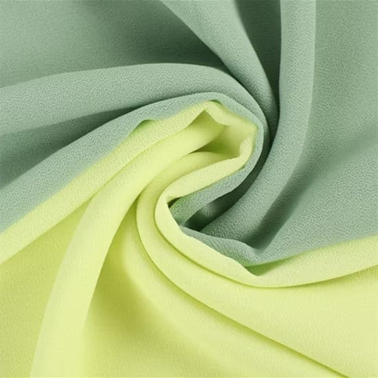 Green and light yellow layered pearl chiffon fabric folds representing eco friendly recycled chiffon textile