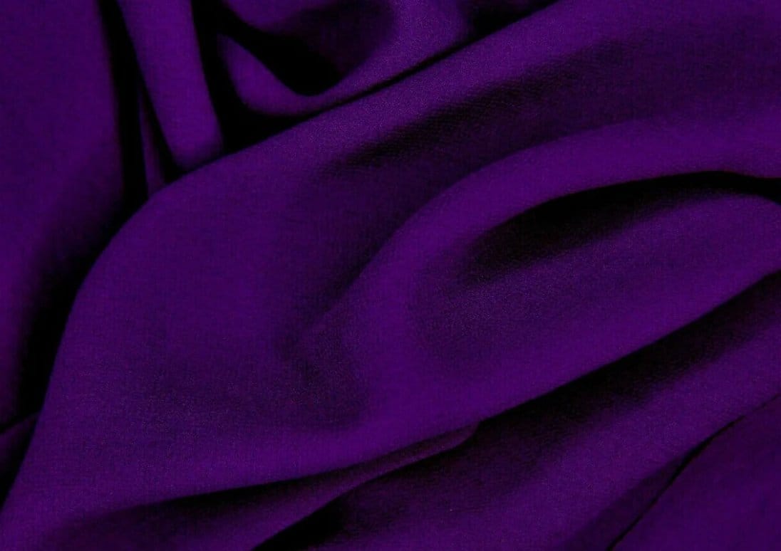 Deep purple georgette fabric arranged in dramatic flowing folds
