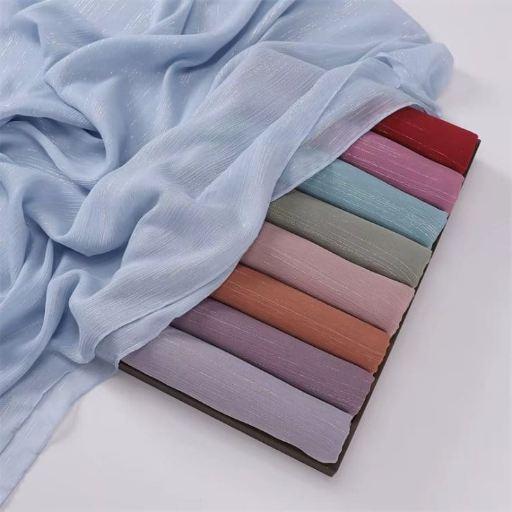Stack of lurex chiffon fabric swatches in various colors for shopping and price comparison