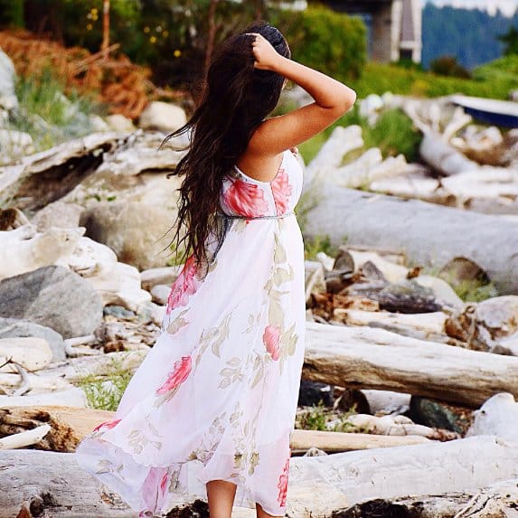Cotton chiffon summer maxi dress with floral print and flowing lightweight fabric worn outdoors