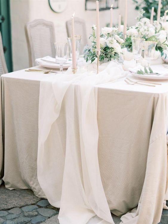 Cotton chiffon table runner draped over a dining table for wedding or event decor