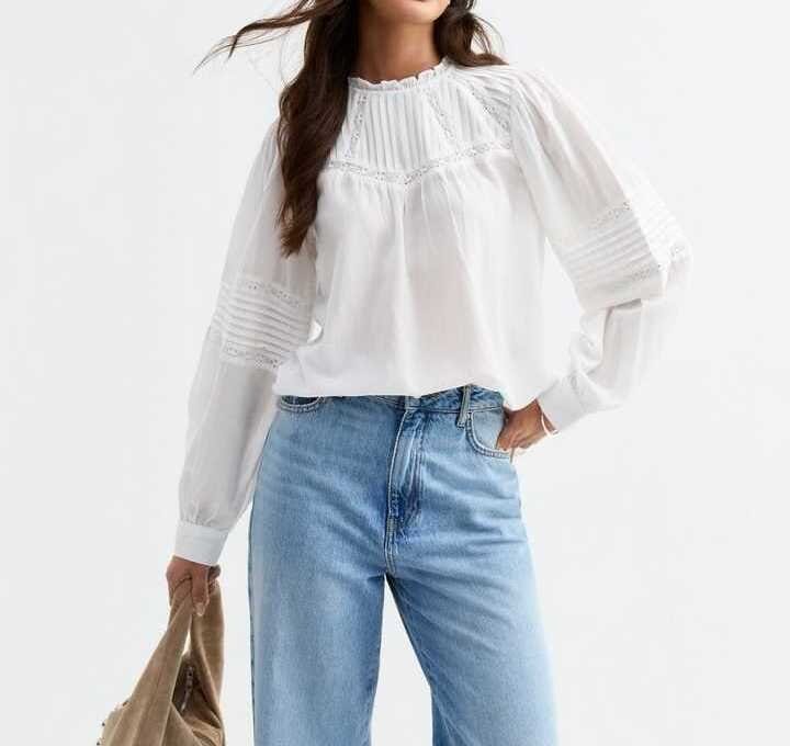 White cotton chiffon blouse with sheer sleeves styled casually with denim jeans