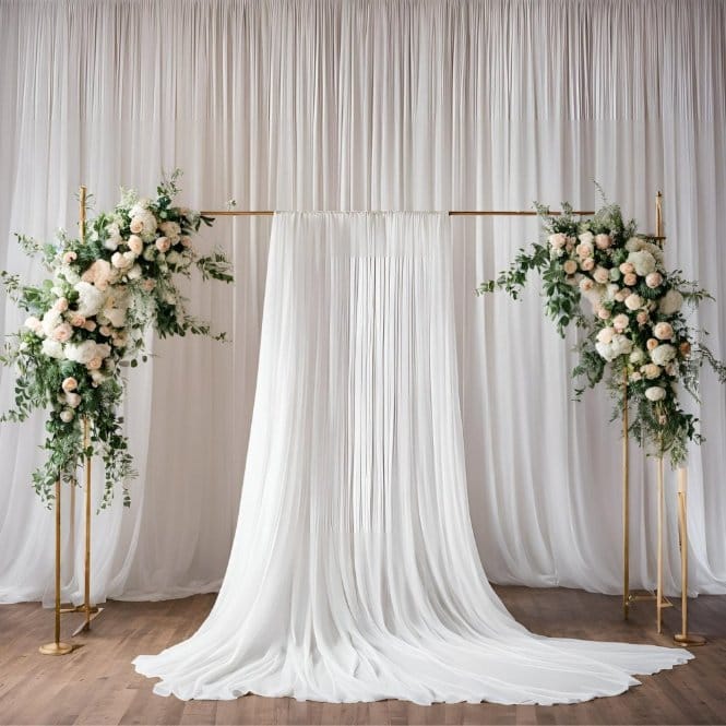 White crepe chiffon fabric draped as elegant event backdrop with soft pleats and floral arrangements for wedding or party decor