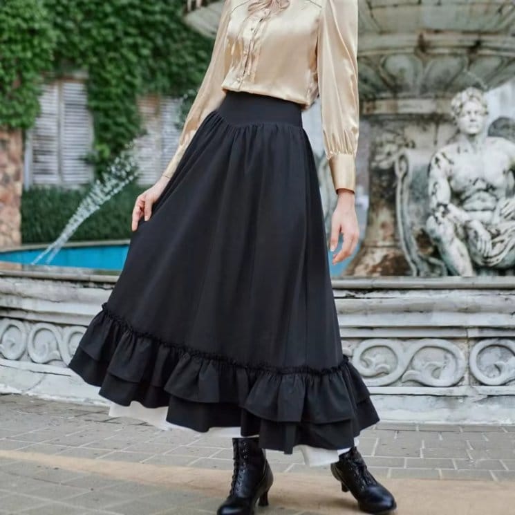 Black double face chiffon midi skirt with ruffle hem worn outdoors, showing soft drape, flowy movement, and lightweight elegant fabric