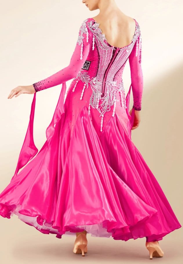 Bright pink pearl chiffon ballroom dance dress with flowing skirt and sparkling embellishments, showing dramatic movement and shine