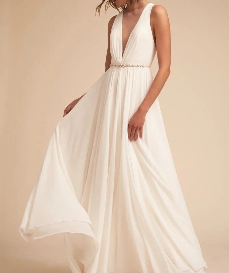 White polyester chiffon bridal gown with deep V neckline and flowing skirt showing soft drape and lightweight movement
