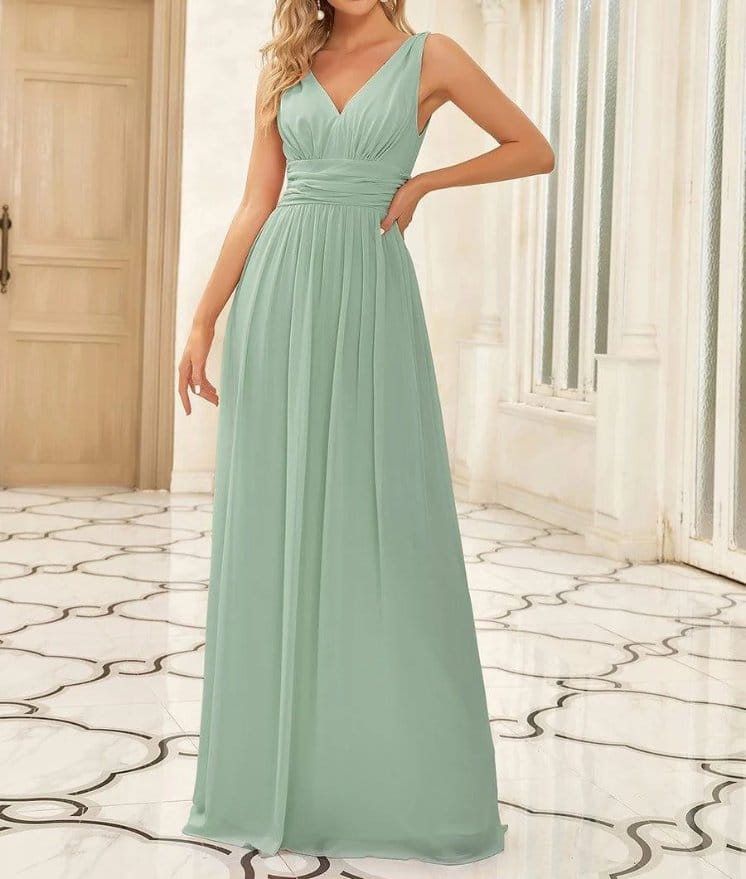 Mint green rayon chiffon bridesmaid dress with flowing skirt and soft drape in an elegant indoor setting