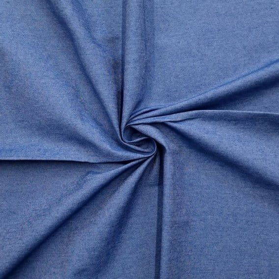 Blue 100% cotton denim fabric in a spiral fold showing soft natural texture and woven construction.
