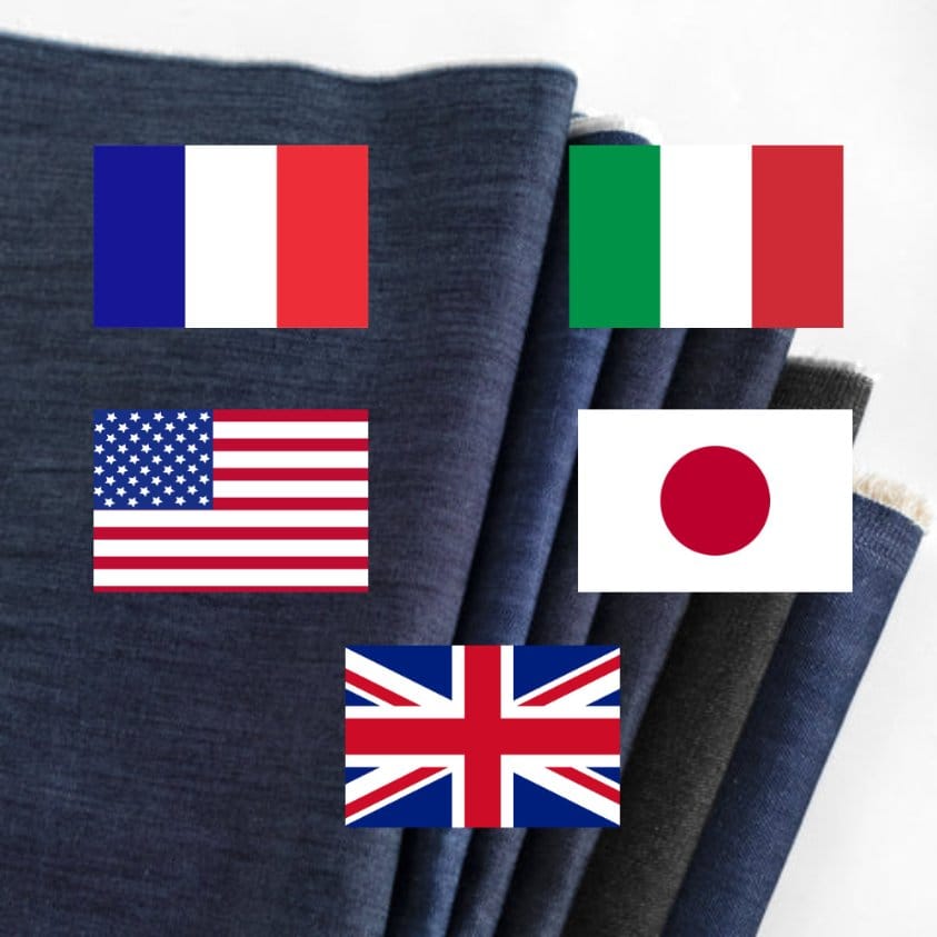 Blue denim fabric with flags representing France, Italy, the United States, Japan, and the United Kingdom in the global story of raw denim.