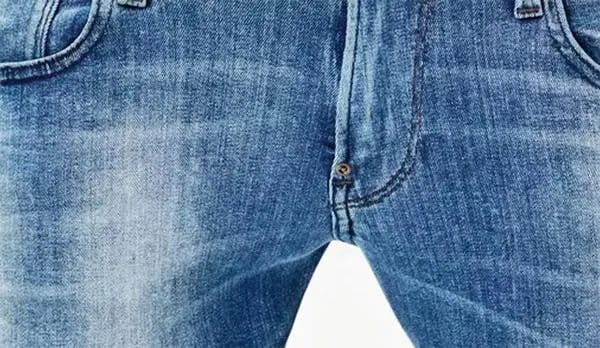 Blue denim fabric with a clean washed finish representing ozone washed denim and low-water fading technology.