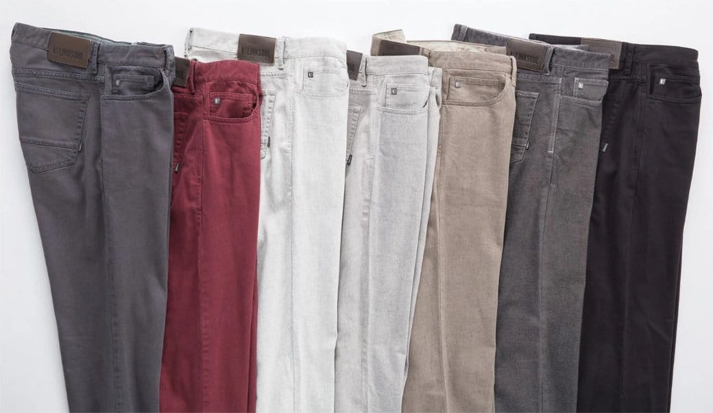 Multiple colored denim jeans arranged together showing product range development
