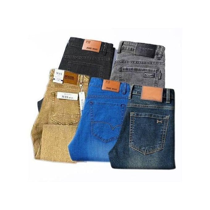 Stack of colored denim jeans representing sustainable shopping choices and ethical fashion