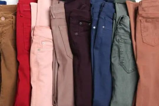Row of colored denim jeans in different shades highlighting product variety for small brands