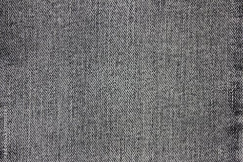 Grey denim fabric close up showing subtle texture and neutral color tone
