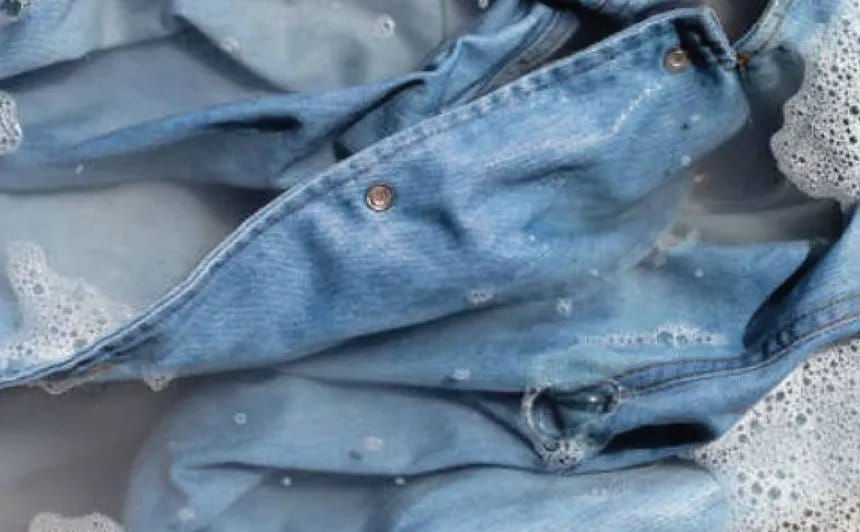 Chambray garment soaking in soapy water, illustrating proper washing and care techniques for chambray fabric.