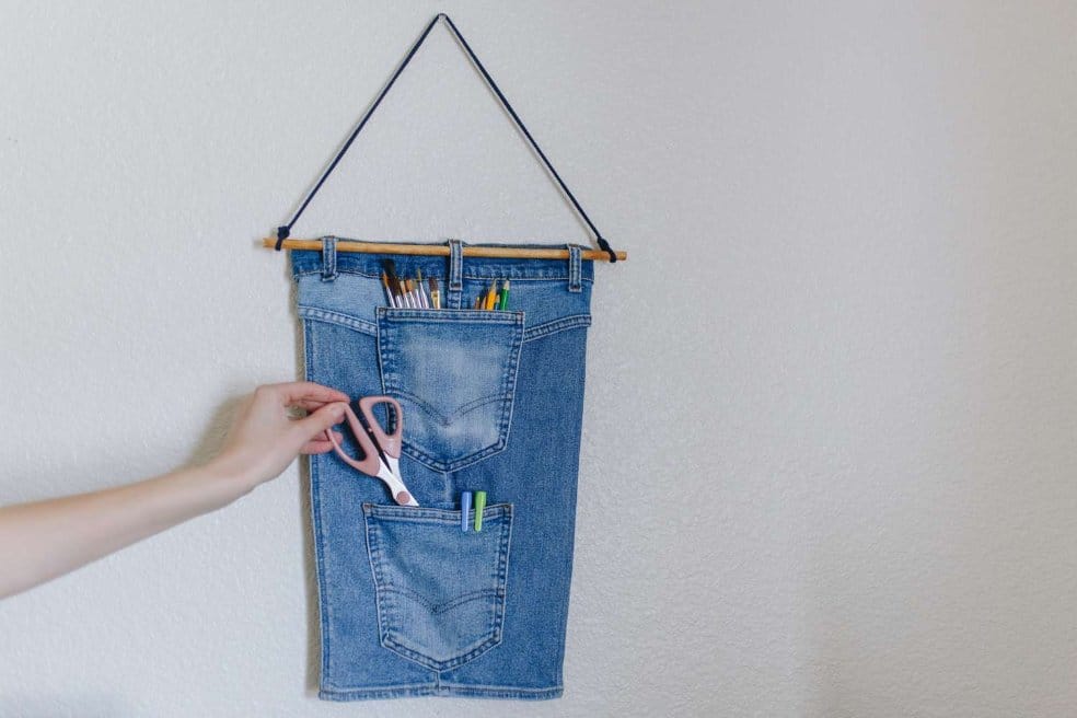 upcycled denim wall organizer made from jeans pockets used for storage and DIY home decor