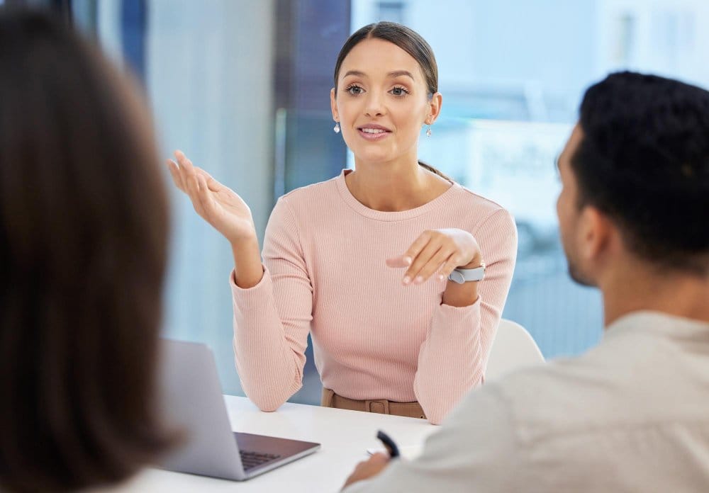 Business professional discussing fabric products with customers while providing expert guidance on nylon fabric features and benefits.
