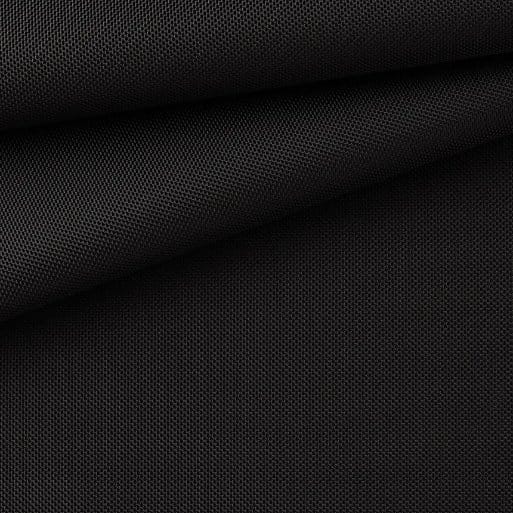 Close-up of black ballistic nylon fabric showing a dense basket weave texture known for exceptional durability, abrasion resistance and strength in luggage, backpacks and protective gear.