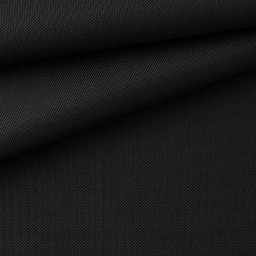 Close-up of black ballistic nylon fabric showing a dense basket weave texture known for exceptional durability, abrasion resistance and strength in luggage, backpacks and protective gear.