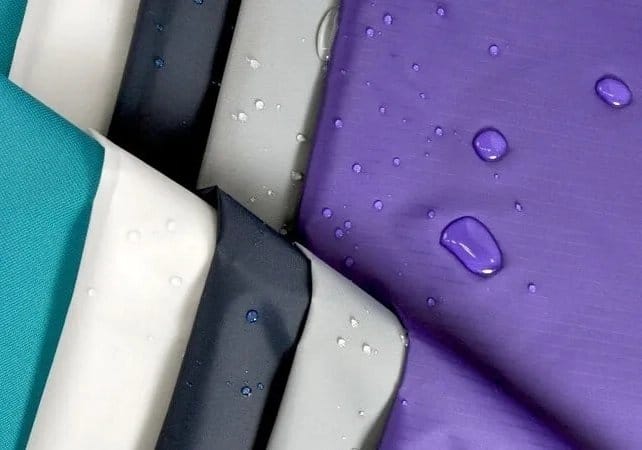 Recycled nylon fabrics with water droplets demonstrating sustainable textile innovation and environmentally conscious fabric production.