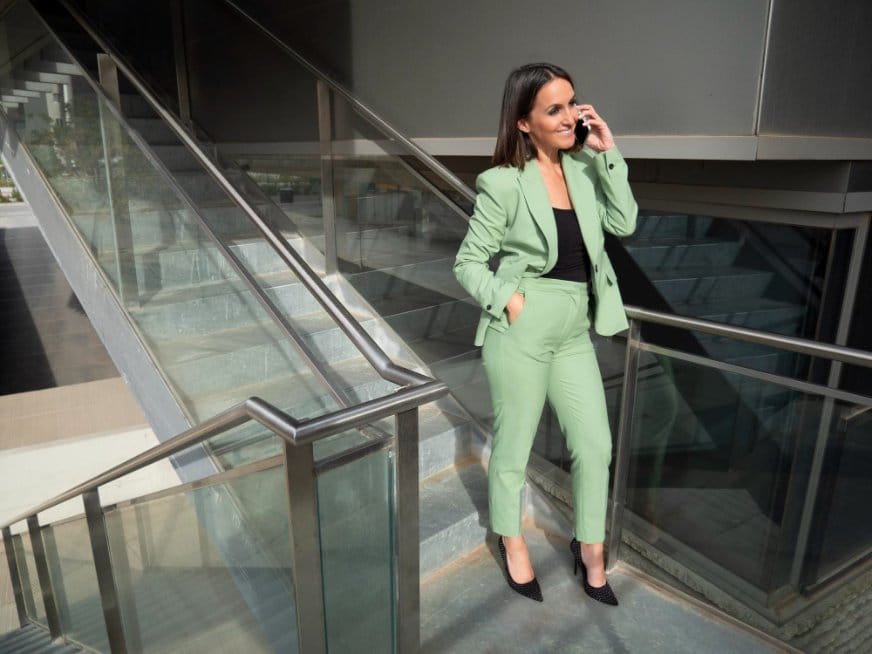 Professional woman wearing a tailored suit enhanced with hidden stretch fabric technology.