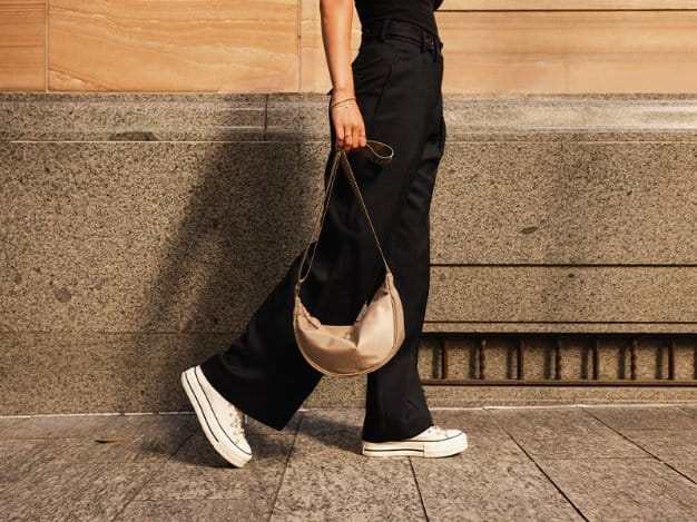 Stylish handbag paired with contemporary fashion clothing showcasing nylon's role in luxury accessories and designer collections.
